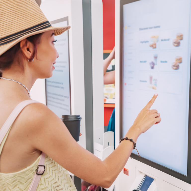 A female customer uses a touchscreen